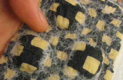 STRONGFELT sample of partial felt used as a resist to control the amount of hair that penetrates the substrate