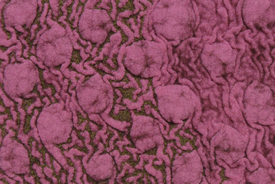 STRONGFELT sample of a stretchy synthetic knit with partial felt used as a texture resist and the use of free-motion embroidery to accent the background texture