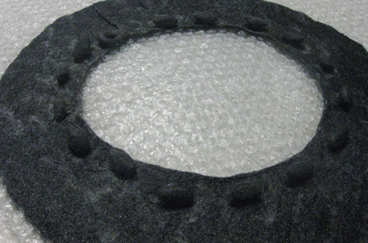 STRONGFELT piece demonstrating the attaching of solid form balls to a surface for sculptural surface protrusions as well as for the function of closures