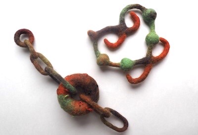 Catriona Iozzo's asymmetrical earring set for Project 1-Under One Skin inspired in color and form by aged iron work