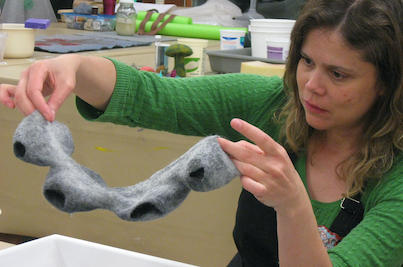 Camila Mesquita studying her form once the template has been removed and before beginning to full. "Felt Technical/Felt Innovative" 2 month Fiber Concentration, Penland School of Crafts, Penland, NC 2011.