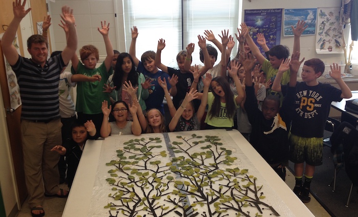 The third group arranged their leaves from the smallest and brightest yellow/green to the largest dark green responding to the design layout of the prior classes...fingers spread like branches and high 5's for the 5th grade!!