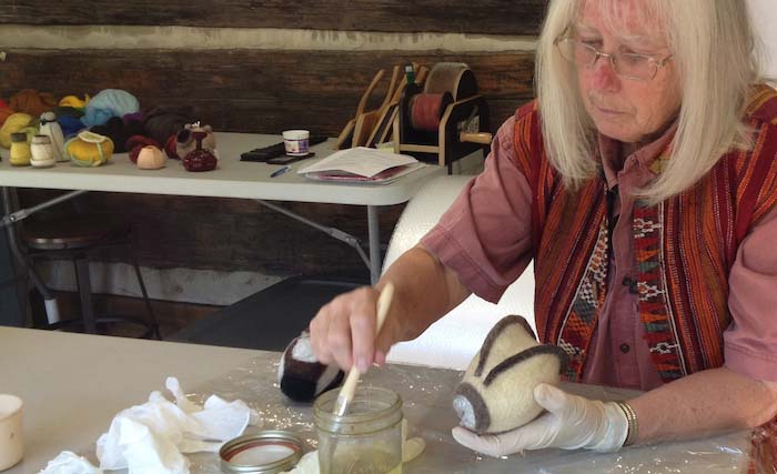 Cheri Miller applying shellac stiffener to a fulled hollow form, STRONGFELT Studio, Asheville, NC, 2014