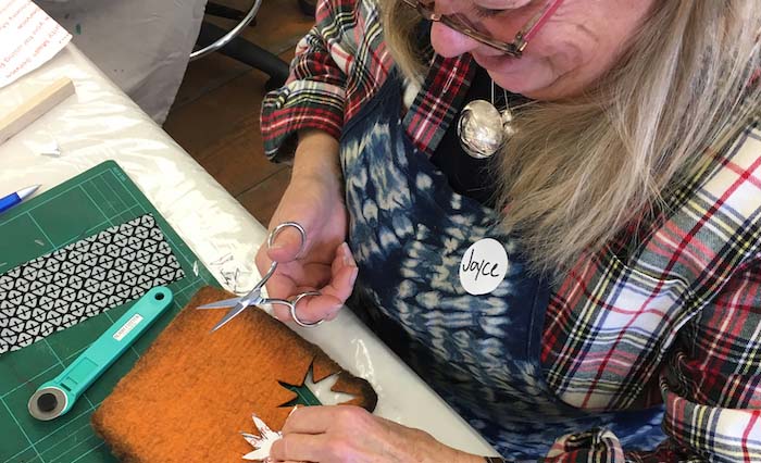 Joyce Gordon designing partial felt patterning in response to the fabrics patterning, Maiwa School of Textiles workshop, Granville Island, Vancouver, CA, 2017