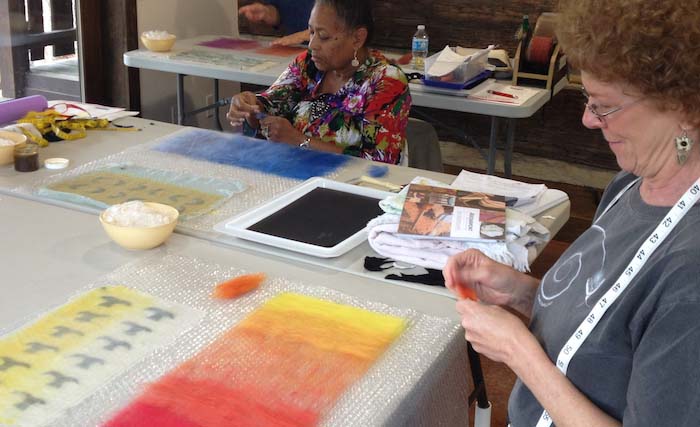 Kate Veness-Meehan (front) and Viola Spells laying out patterns & color gradations, STRONGFELT Studio workshop, Asheville, NC, 2014