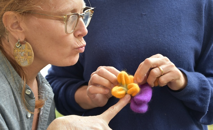 Lisa Klakulak appreciating the puckered protrusions on Evelyn Carcaterra's study of dramatic differential shrinakge, Waltensburg, Switzerland, 2023, photo credit: Stefanie Hofmann