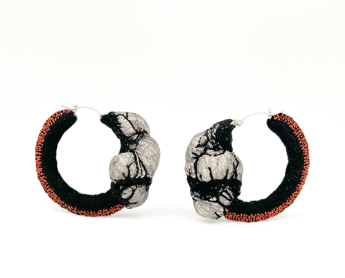 Black and white fabric hoop earrings, orange trim